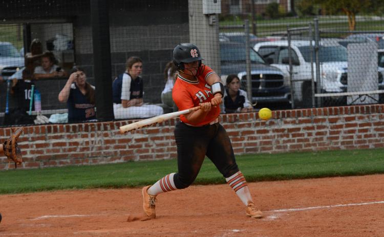 Senior outfielder Alexis Davis hits the ball into the gap in center field in the 9-3 win against Habersham Central in the Lady Dogs home opener Tuesday, Aug. 15.