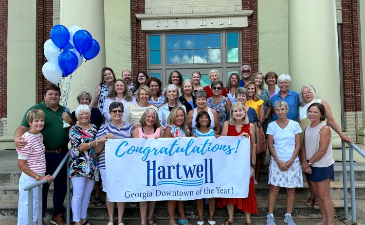Pictured celebrating the City of Hartwell being named the Georgia Downtown of the Year are (first row, from left) Main Street volunteers Mary Lynn Johnson, Nancy Butler, Deb Kulcsar, Wendy Patterson, Carol Beazley, Diane Evans, Bo Bynum, Gretchen McClymont; (second row, from left) Main Street Coordinator Peggy Vickery, City Manager Jon Herschell and Main Street volunteersTammy Hutchinson, Nancy Hardigree, Helene Brown, Pat Harper, Sandra Baker; (third row, from left) Main Street volunteers