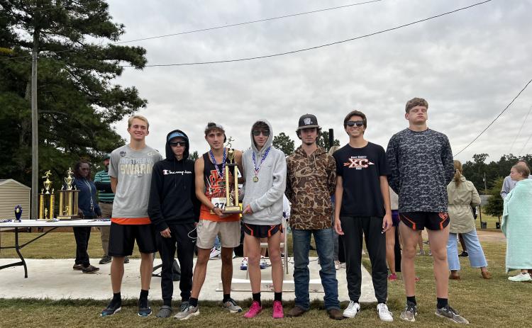 Pictured is the Hart County High School boys cross country team hoisting the first place trophy as they placed first in the purple division at Athens Christian Oct. 14. From left to right is Will Bell, Damian Childress, Nate Harris, Braydon Lane, Donavin Layman, Zach Simmons, and Ethan Stovall. 