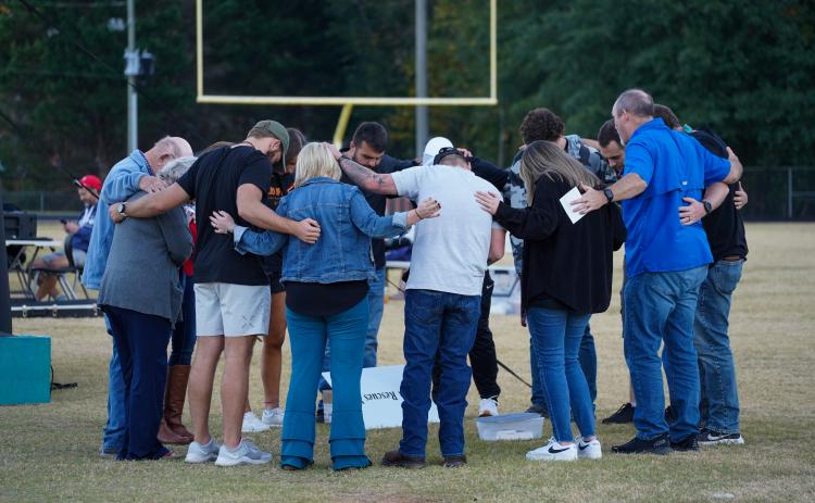 Pictured is the Fields of Faith leadership team praying before the event. 