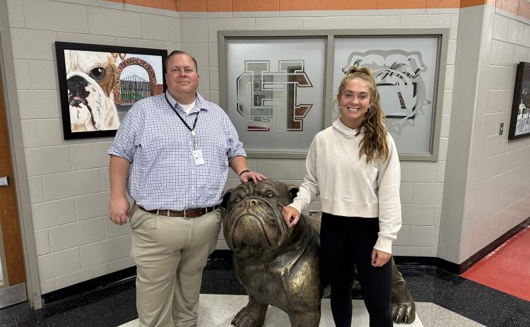 Hart County High School senior Dakota Phillips, pictured right, poses for a photo with Principal Kevin Gaines, left, after receiving news that she was selected to serve on the State School Superintendent’s Advisory Council.