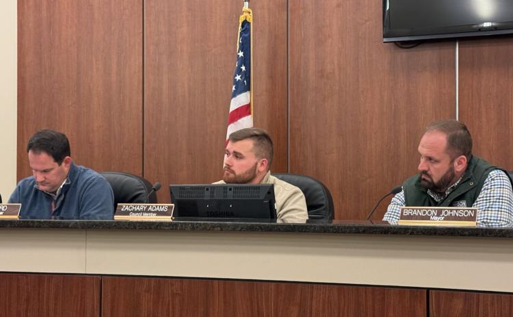 Council members (from left to right) Dan Leard, Zach Adams, and mayor Brandon Johnson hear debate on local alcohol license 