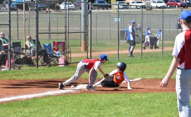 Xavier Robinson (right) slides into third base on Opening Day for Hart County Little League.