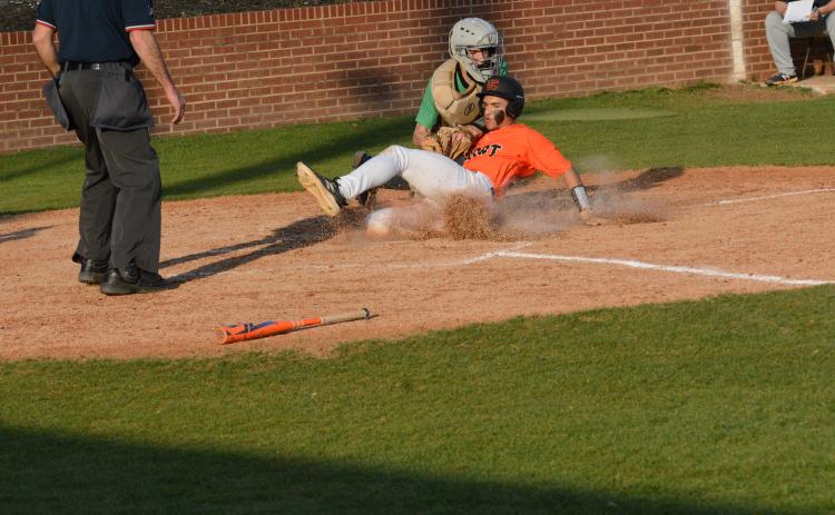 Freshman outfielder Kaidyn Allen slides safely into home plate during the 11-5 loss to Franklin County on March 14.
