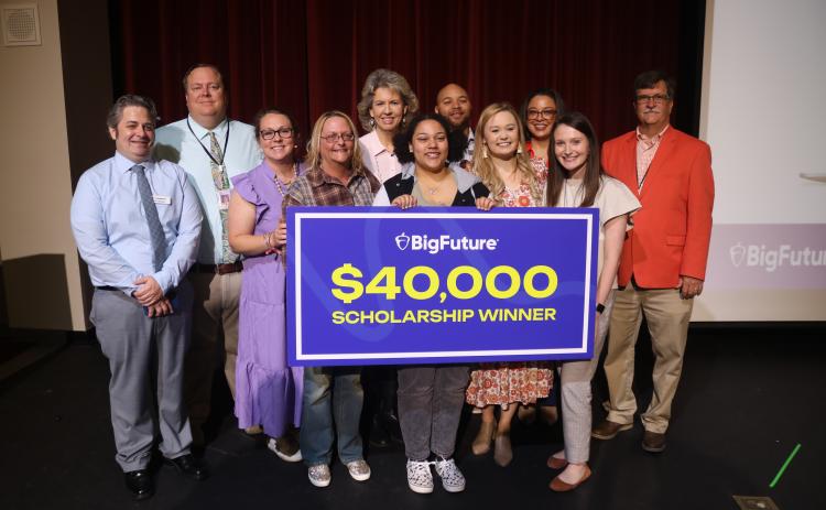 Hart County High School junior Jada Phelps, pictured center, stands alongside her mother, Leanne Phelps, left, as well as Hart County High School administrators, counselors, and College Board representatives after Jada received a $40,000 BigFuture scholarship.