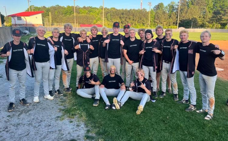 The Hart County High School baseball team shows off their “April Dawgs” shirts after sweeping the Patriots of Sandy Creek on April 23, 9-3 and 12-2, to advance to the Sweet Sixteen.