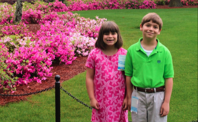 Right before the rains came, Vivian Fargason (left) and her brother Reid pose for a picture in front of the Augusta National clubhouse on April 9, 2019. 