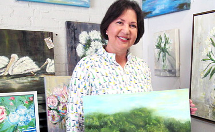 Angie Short posing with her favorite painting from her oeuvre. Photo by Rachel Black.